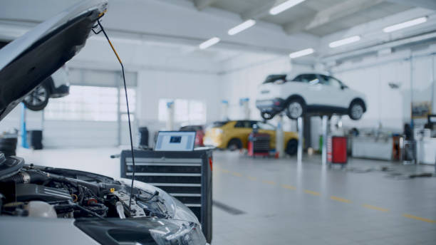 Toolbox Cart With Laptop Placed Next To A Car Engine In The Auto Repair Shop,Ready To Diagnose And Fix With Precision