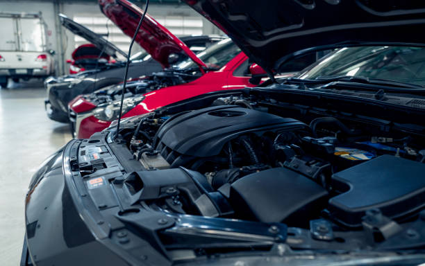 Auto repair shop. Cars open bonnet parked in garage for repair and maintenance service. Car check up at service station. Car waiting for inspection in auto repair shop. Car maintenance and checklist.